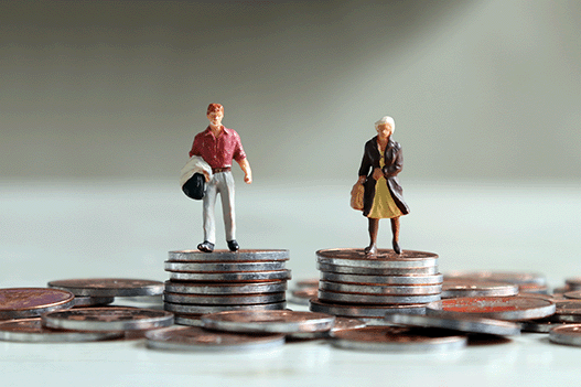 Two figurines standing on coins